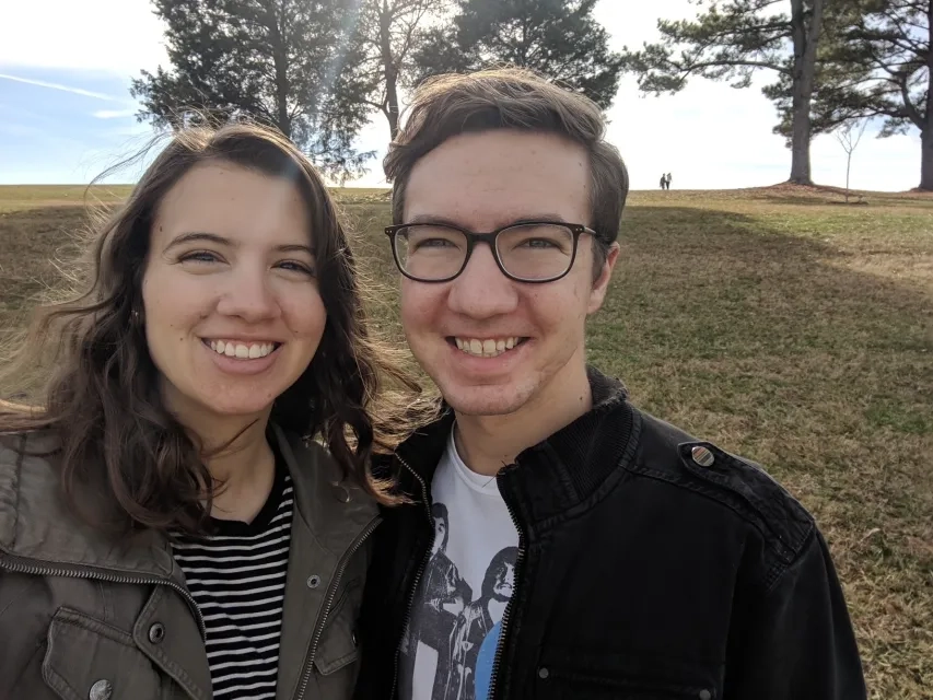Summer and her partner say cheese in nature. 